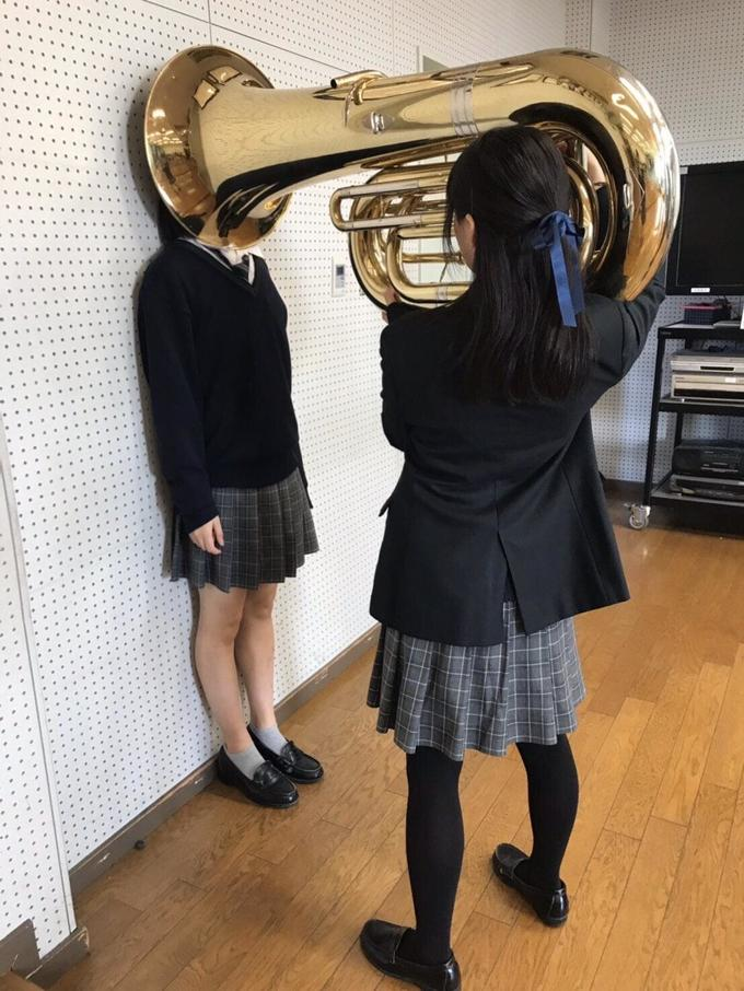 Girl Putting Tuba on Girl's Head Meme Preview Image